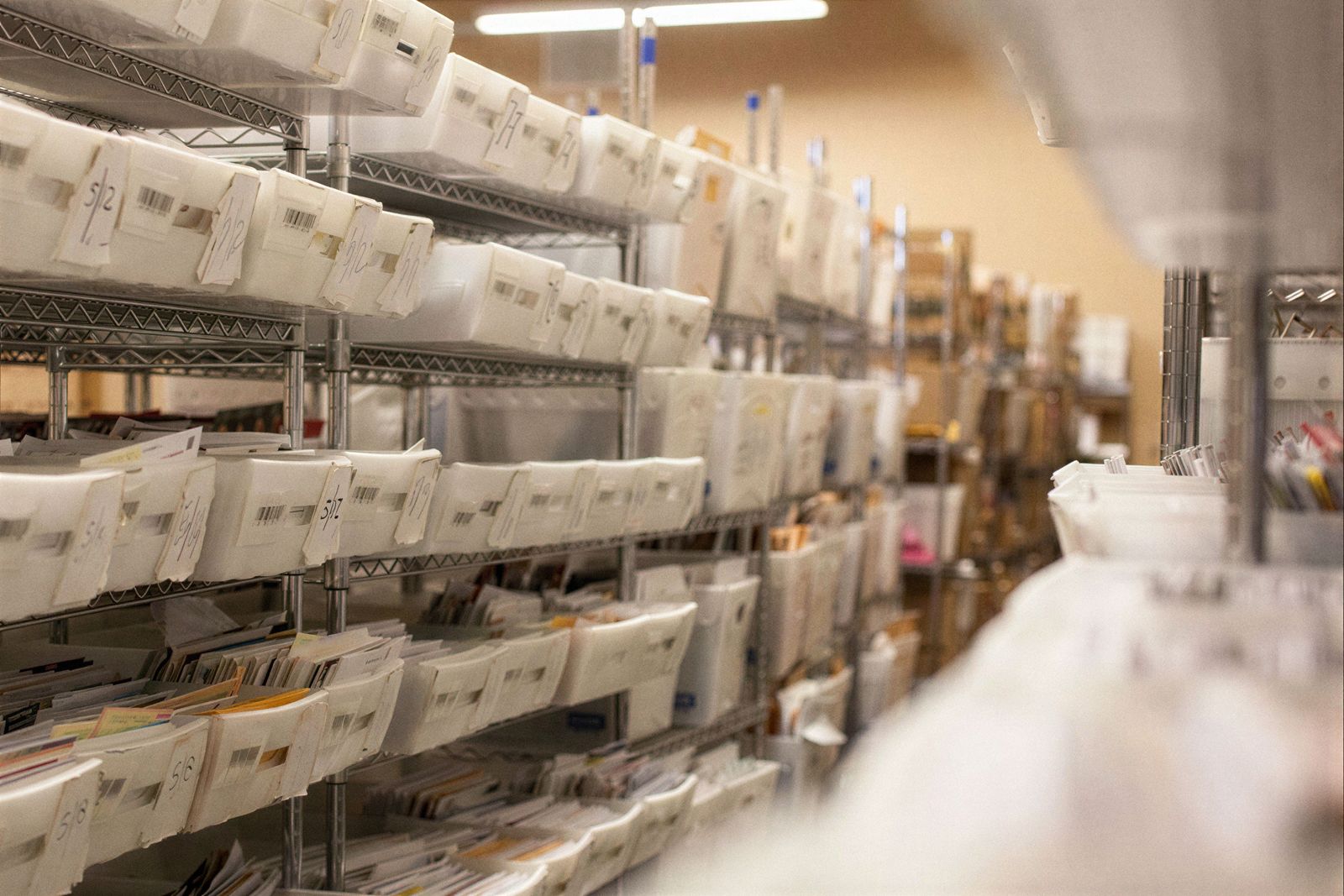 An aisle of mail tubs in the Earth Class Mail warehouse